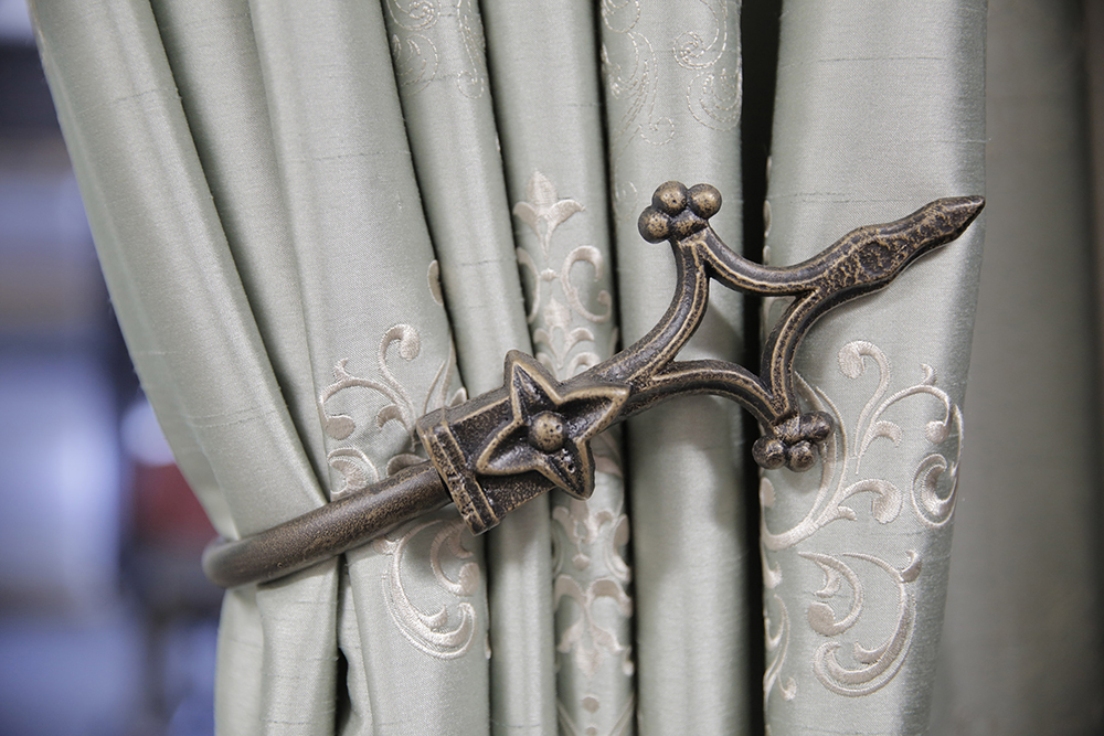 An intricate and elegant tie back adds the fine details in designer window fashions. 
