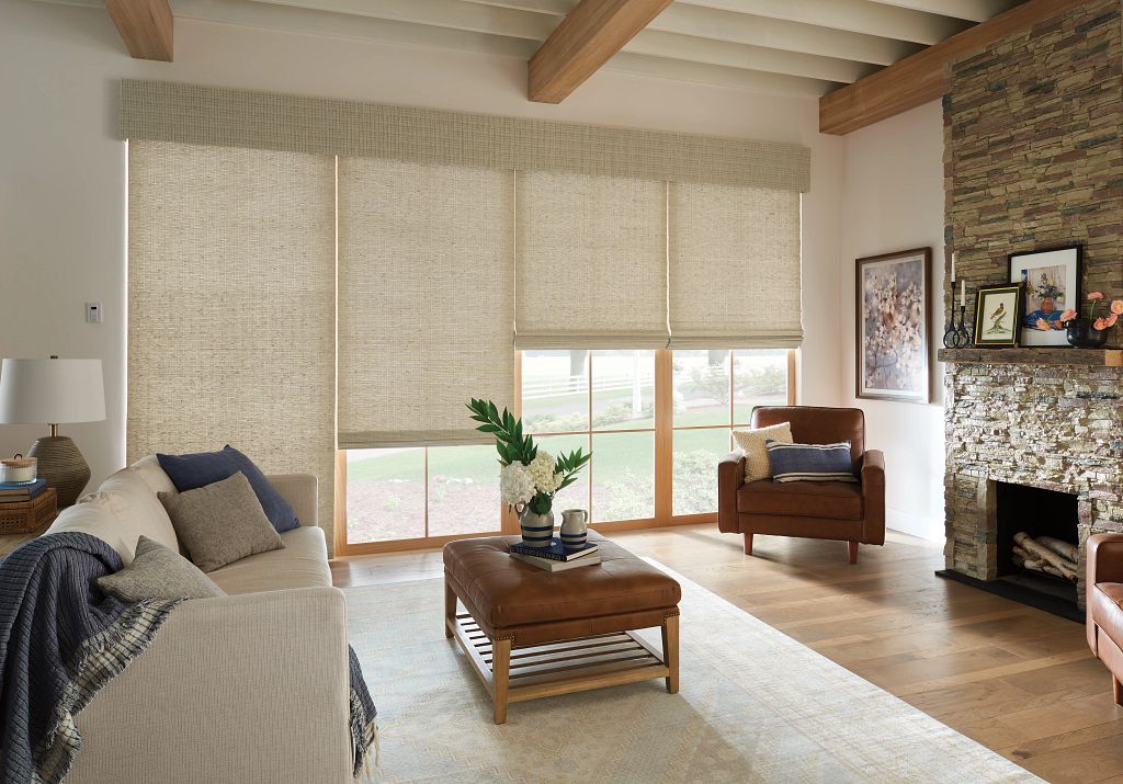 Neutral colors fill this room with natural roman shades bringing texture and warmth