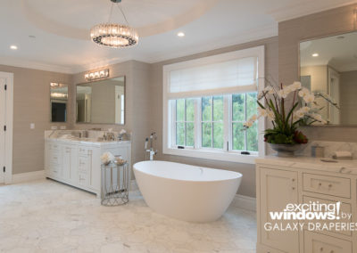 Light-filtering shades in the master bathroom can be raised and lowered with the touch of a button and allow natural light to pass through without sacrificing privacy.