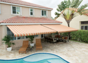 Picture of a retractable awning installed on a house with a pool.