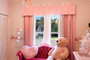 Picture of a pink custom valance in a child's bedroom.