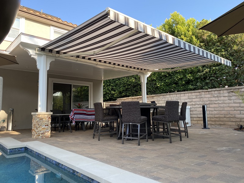 this retractable awning covers a seating area when extended