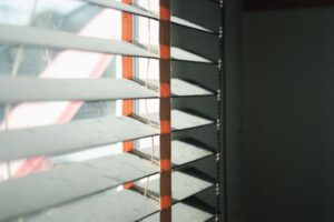 Blinds on a window with light coming through